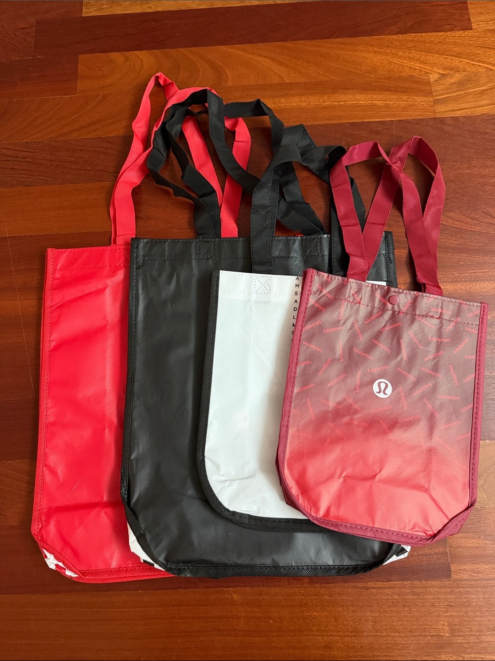 lululemon athletica tote bags in red, black, white, and burgundy